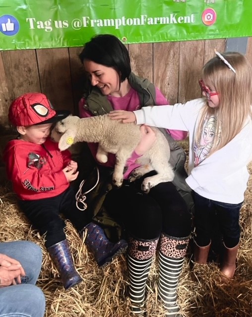 Lamb On Adults Lap With Kids