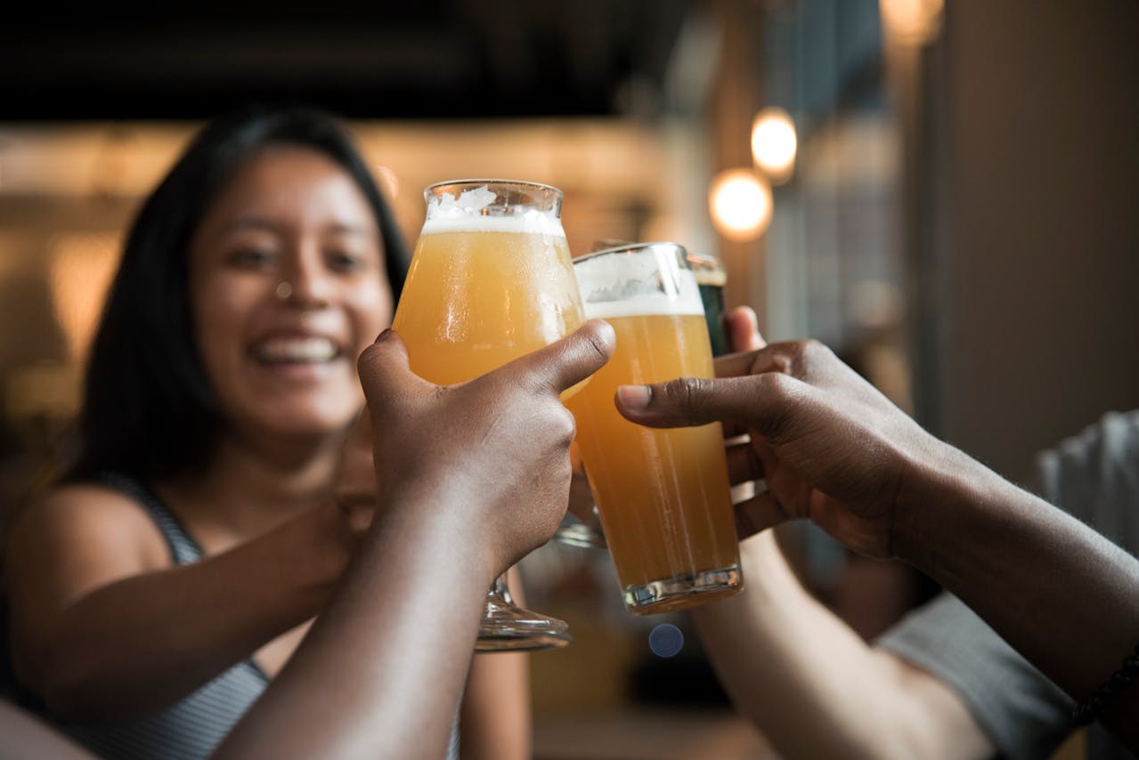 Group of friends enjoying a drink in a pub, cheersing