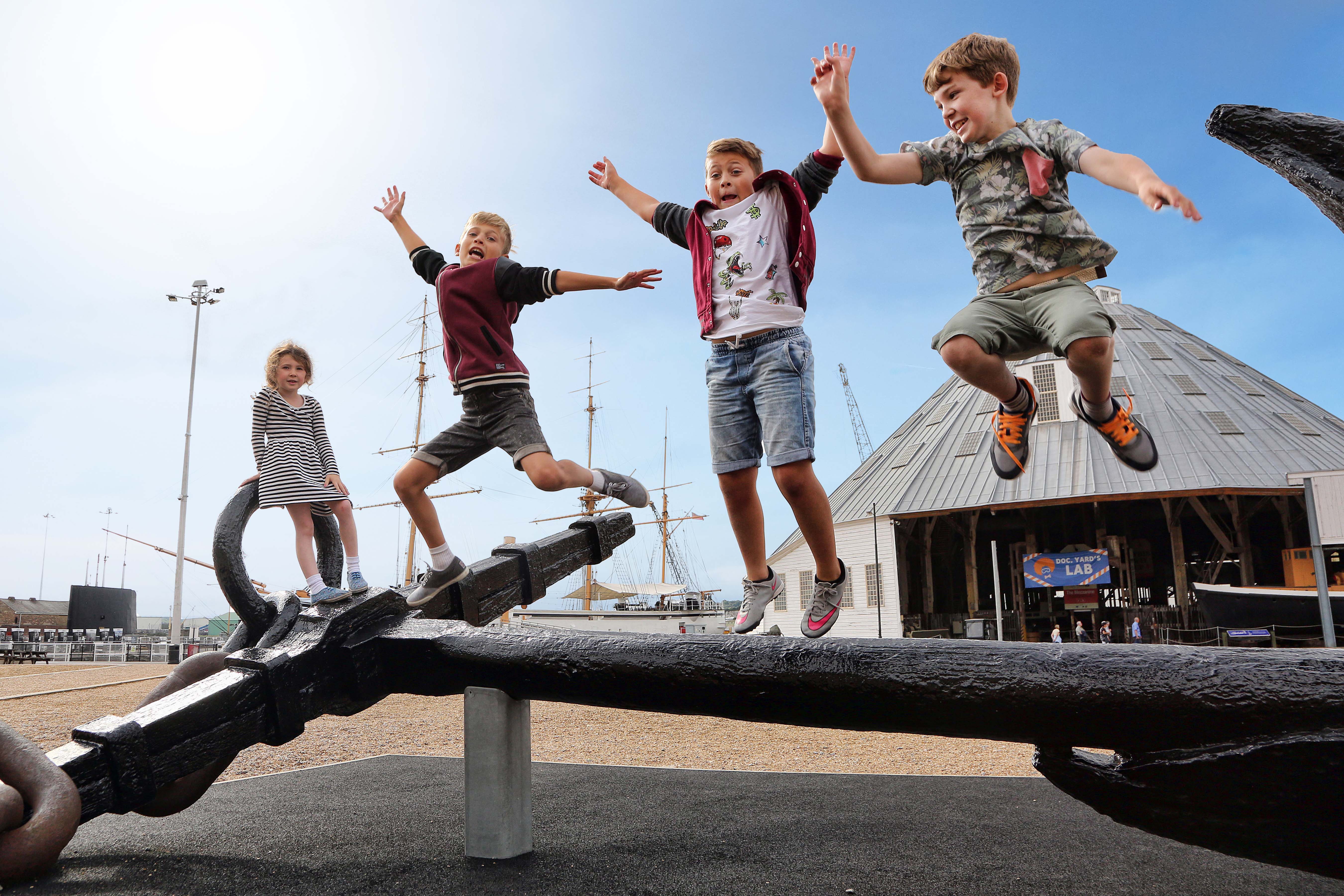 Four children leaping off the anchor at Historic Dockyard Chatham