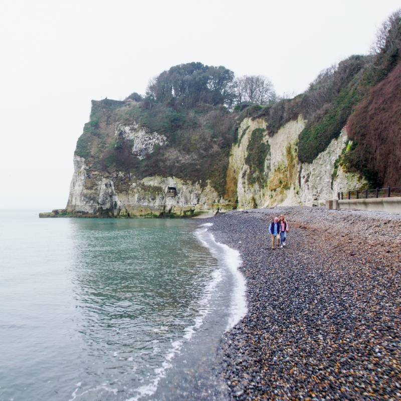 Couple walking on the beach at St Margaret's Bay