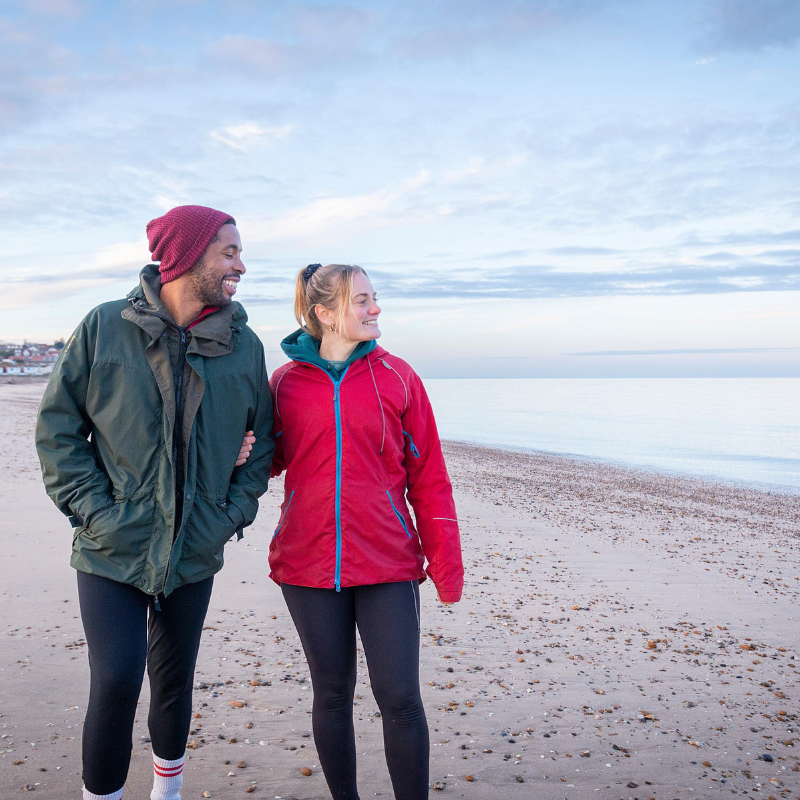 Couple walking along the beach at Minster-on-Sea