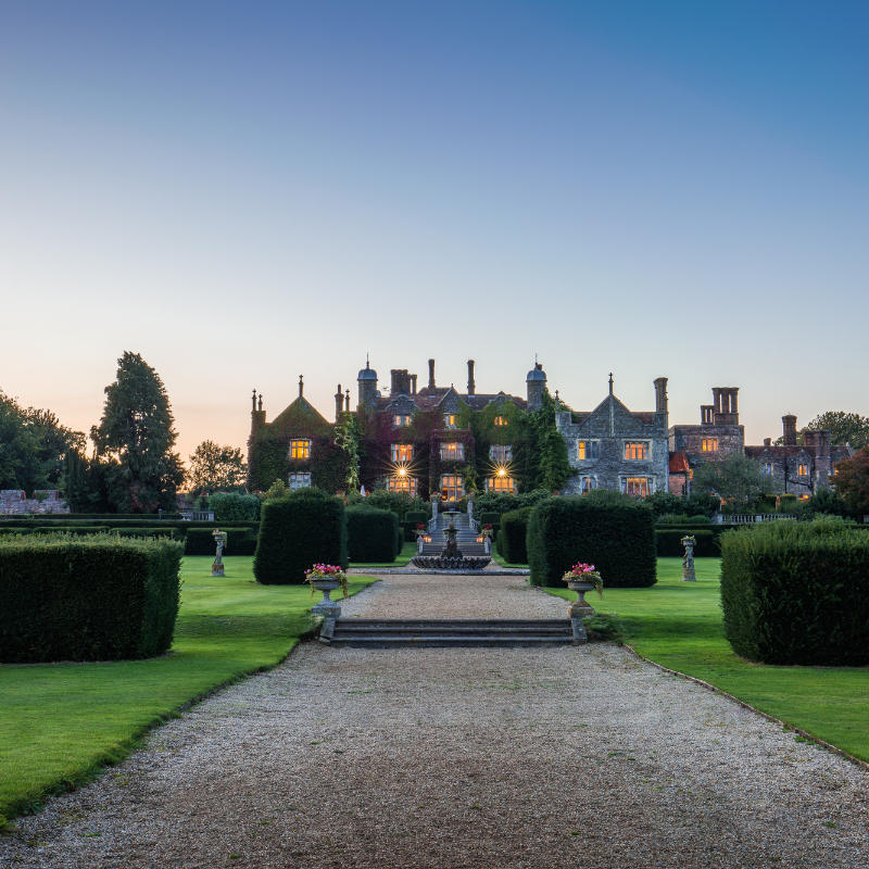 Evening view of Eastwell Manor, lit up