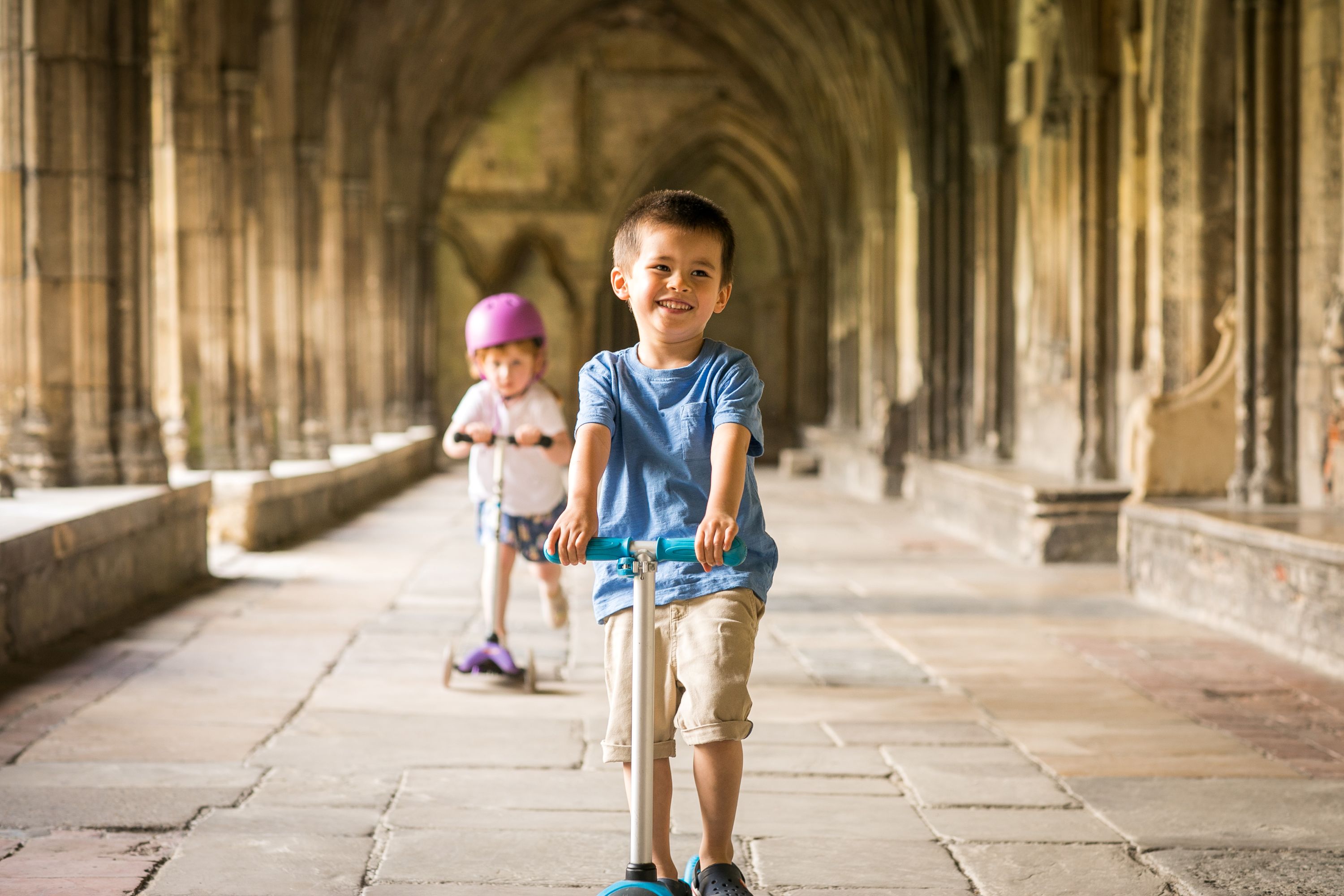Children on scooters in Canterbury Cathedral precinct