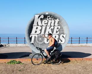 Col on his bike, the sea in the background