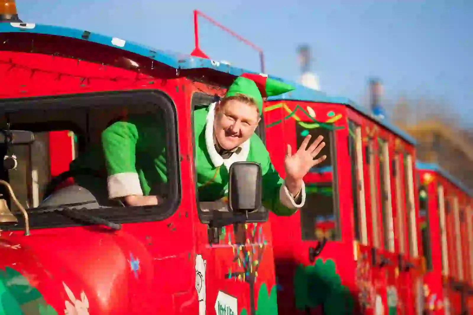 Christmas elf waving on train